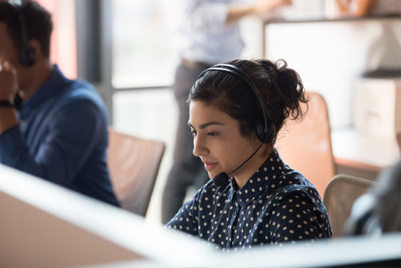 A woman working with a phone headset on