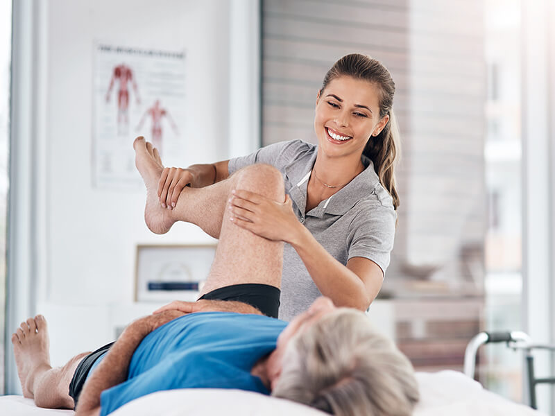 A chiropractor adjusts a patient