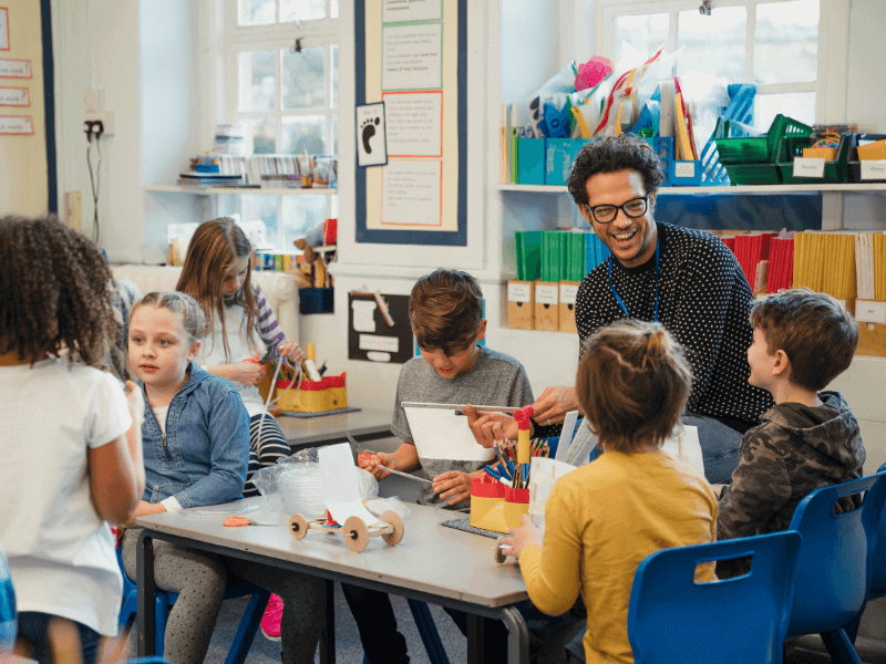 A teacher interacts with children in the classroom