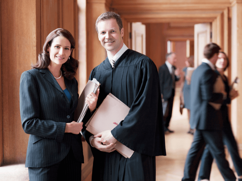 Two government employees pose together