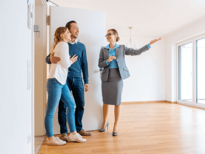 A realtor shows a couple a home