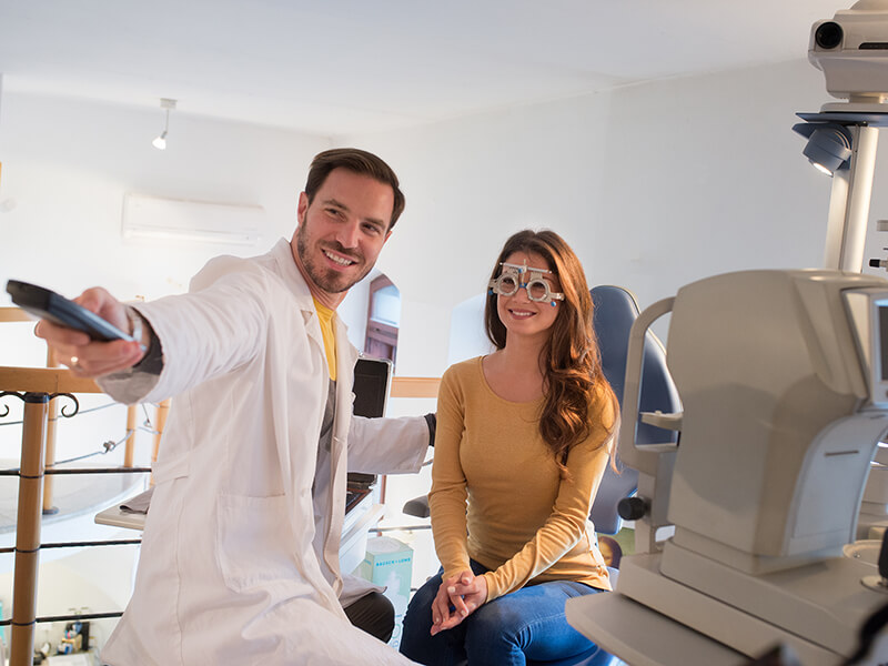 An optometrist works with a patient