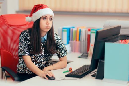 Overwhelmed employee working while wearing holiday attire