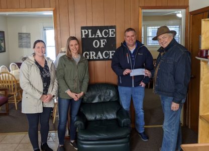 Staff at Forest Lake Food Shelf holding a donation check