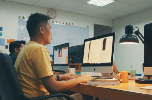 A person working hard on a desktop computer