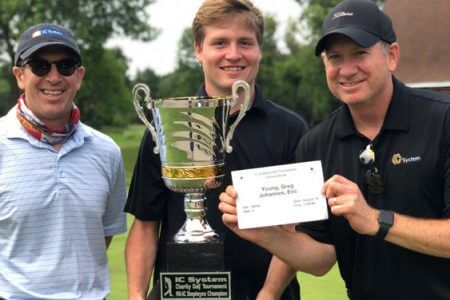 Golfers holding up their trophy and certificate at the IC Systems Annual Charity Golf Tournament