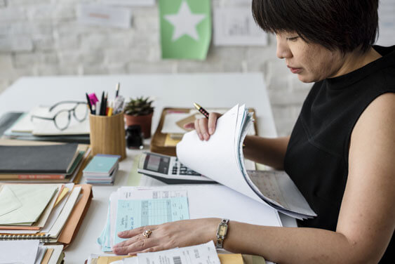 A woman looking through paperwork