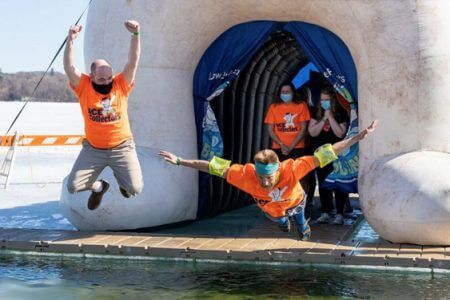 IC System Team member jumps into the lake for the 2021 Polar Plunge